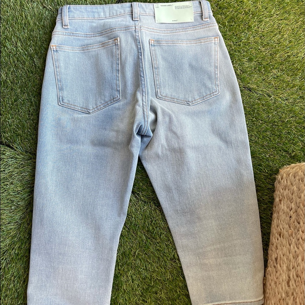 Off-white knee length light blue denim shorts. 27